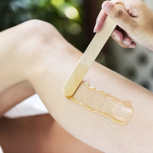 woman-getting-legs-waxed-spa-min